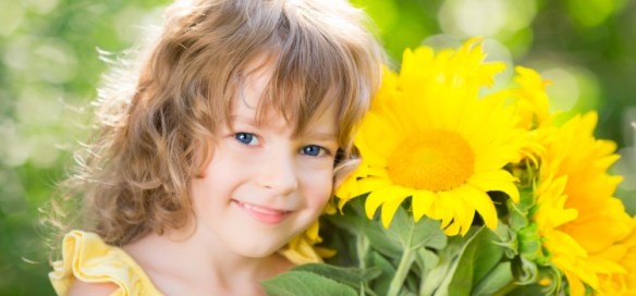 Happy-child-with-bouquet-of-flowers-750x350